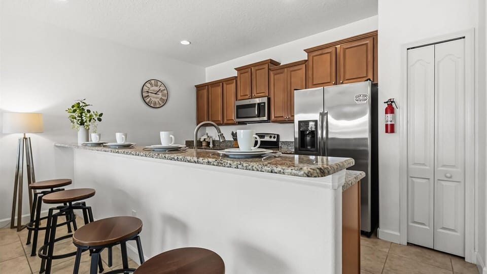 Fully Equipped Kitchen: Cook your favourite meals in this modern kitchen featuring stainless steel appliances and granite countertops.