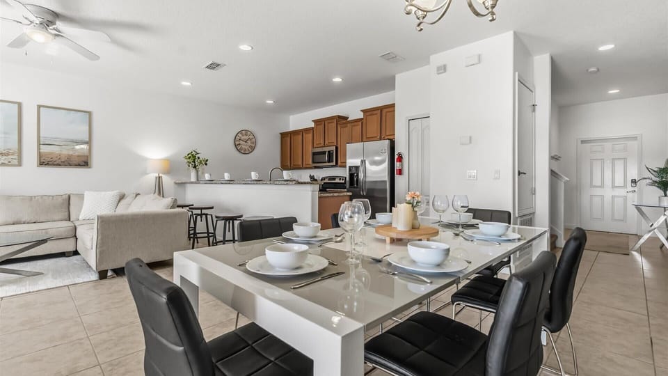 Dining Space: Gather for meals at the dining table with pool views and open flow to the kitchen.