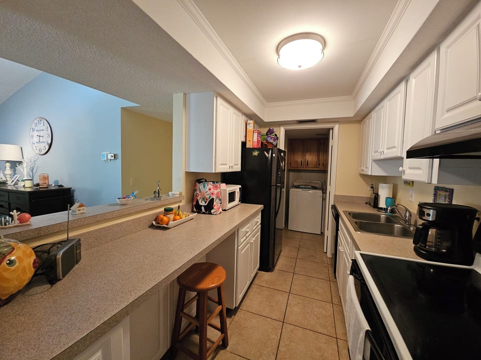 KITCHEN AND VIEW OF LAUNDRY