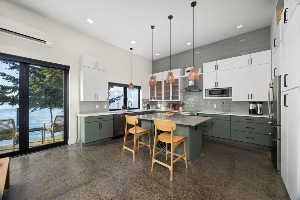 Chef-ready kitchen with modern appliances, breakfast bar seating, and warm natural light throughout.