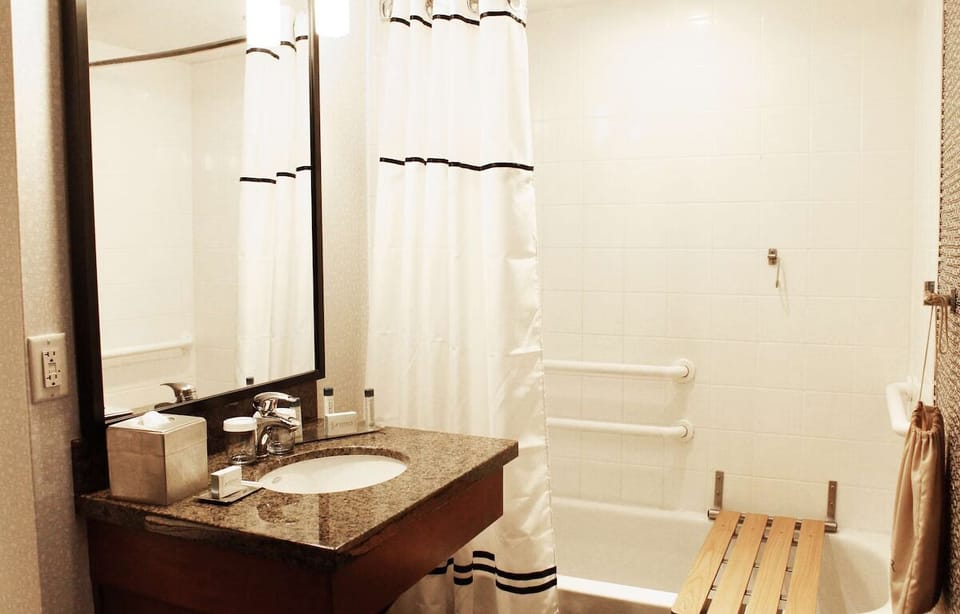 Freshen up at a polished vanity with neatly stocked essentials.