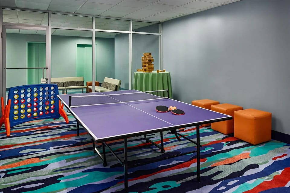 Challenge friends to ping-pong and games in a colorful room.