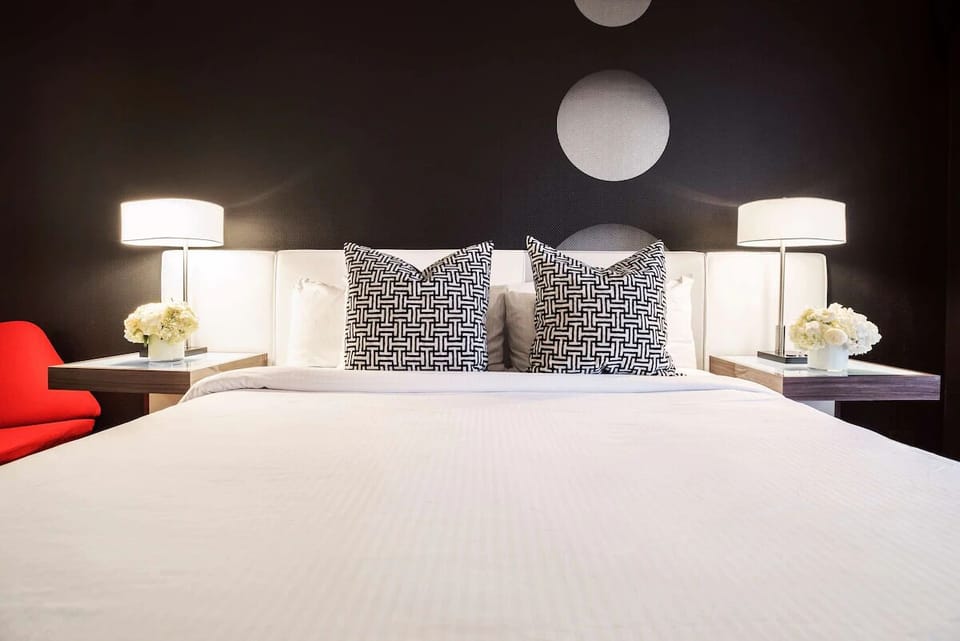 Drift off beneath soft lighting and designer-patterned pillows.