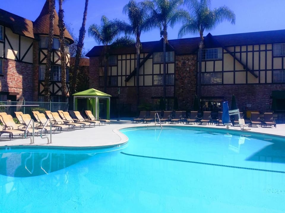 Heated swimming pool, hot tub and poolside loungers.