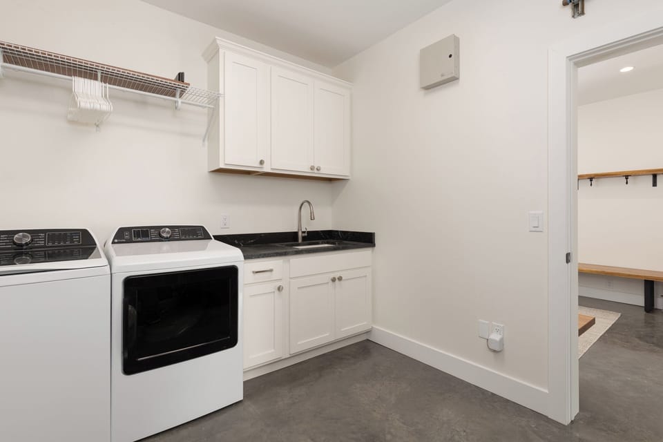 Laundy Room with high efficiency washer/dryer off the Entryway