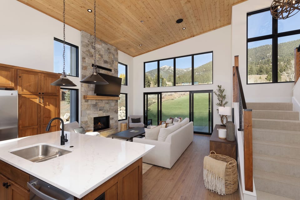 Kitchen with island seating for 3 flows into the greatroom