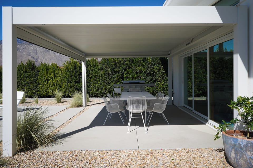 Covered dining for 8 with retractable roof and lights with BBQ gas griddle.