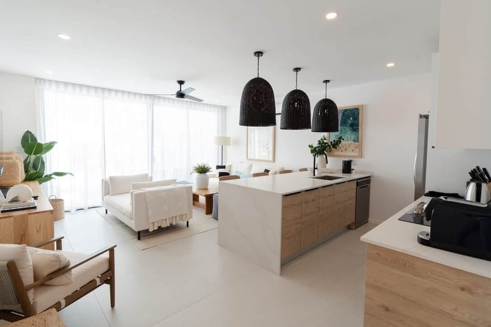Spacious open-plan kitchen and living area with modern finishes, perfect for relaxing or entertainin