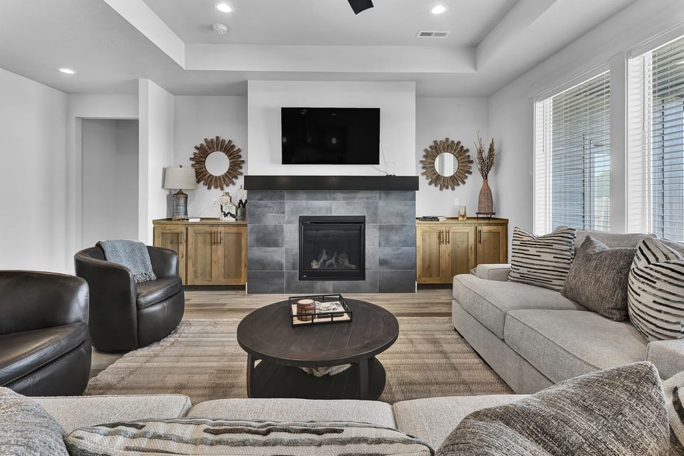 Living room with TV, gas fireplace, and swivel chairs