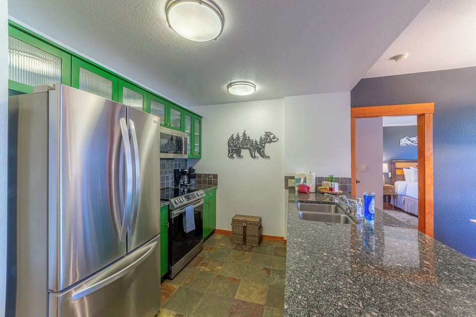 Upgraded kitchen has stainless steel appliances.