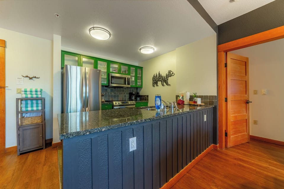 Full kitchen w/ solid stone countertops.
