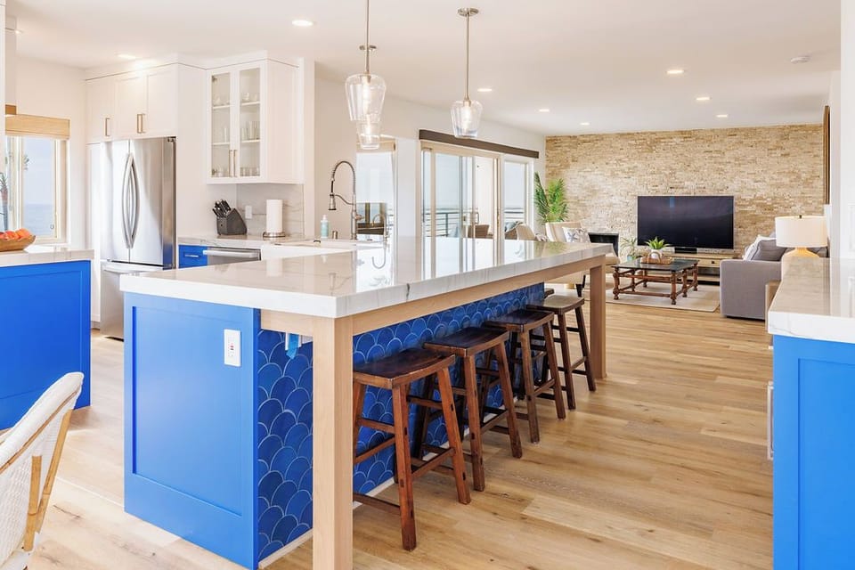 Additional seating for seven at the kitchen counter with sleek bar stools.