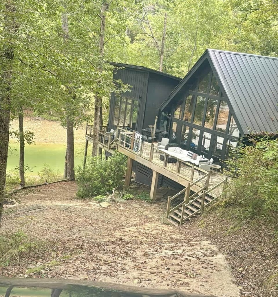 Peaceful wooded setting with stunning lake views and easy water access.