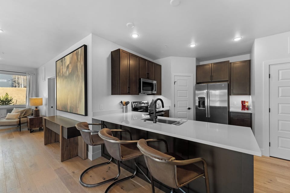 Cook together at this spacious island with sleek appliances and stylish bar seating for four.
