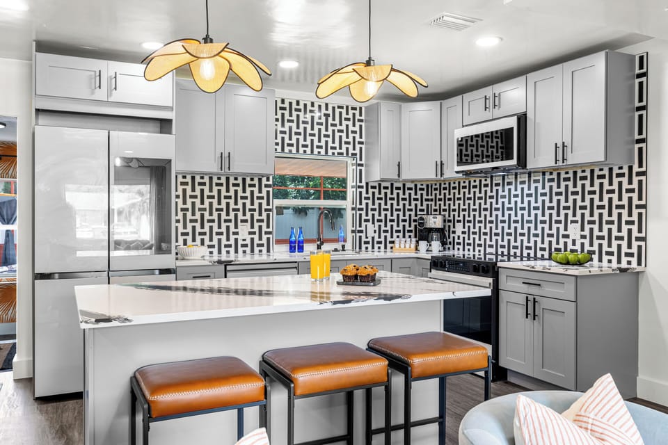 Modern kitchen with vibrant accents, stylish seating & all your essentials!