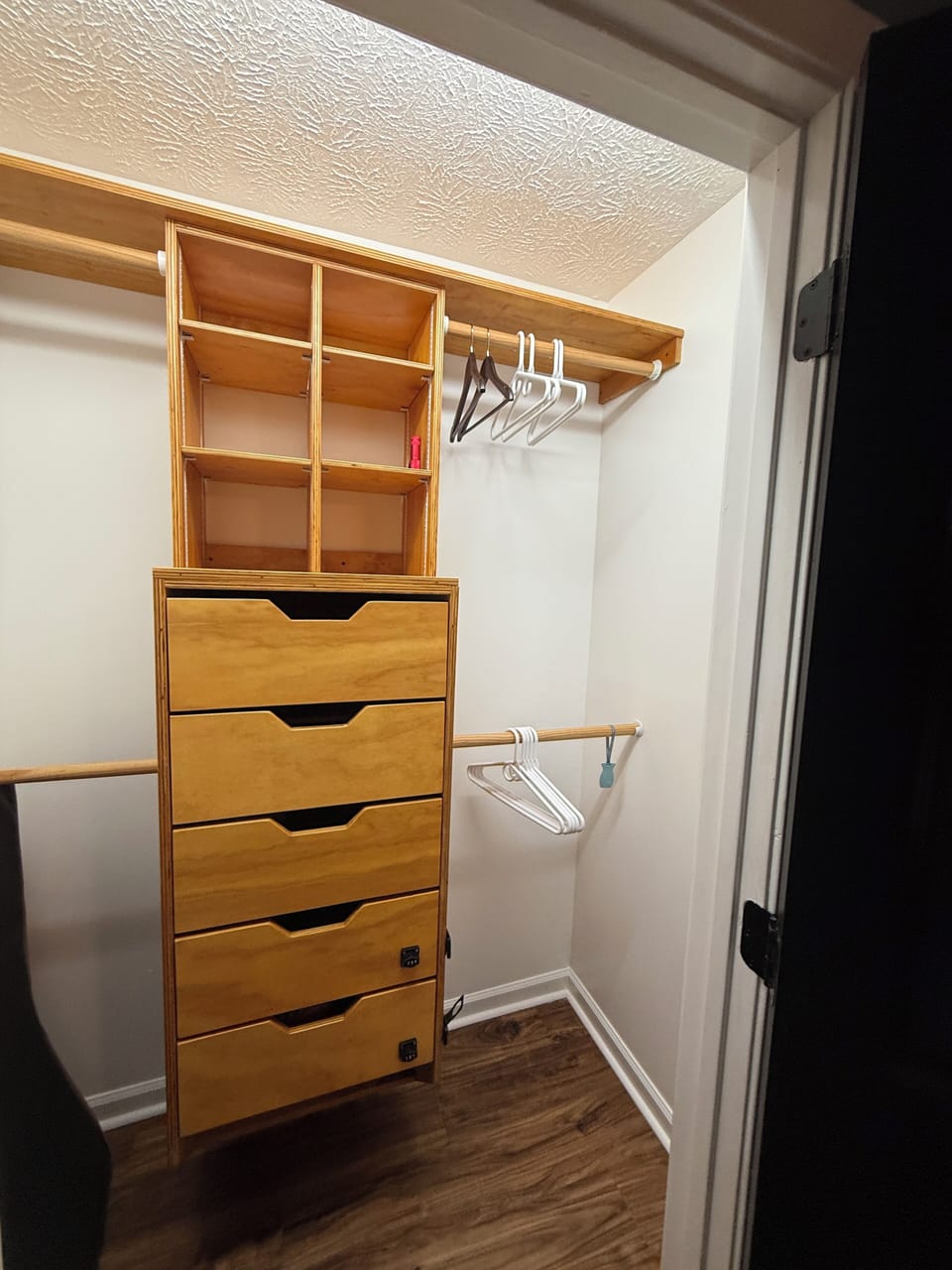 Master bedroom closet featuring built ins for personal items.