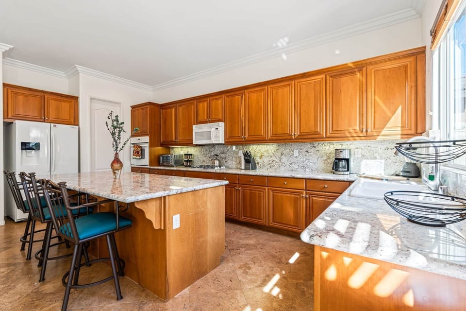 Step into a warm and inviting kitchen designed for both cooking and gathering. With expansive granit