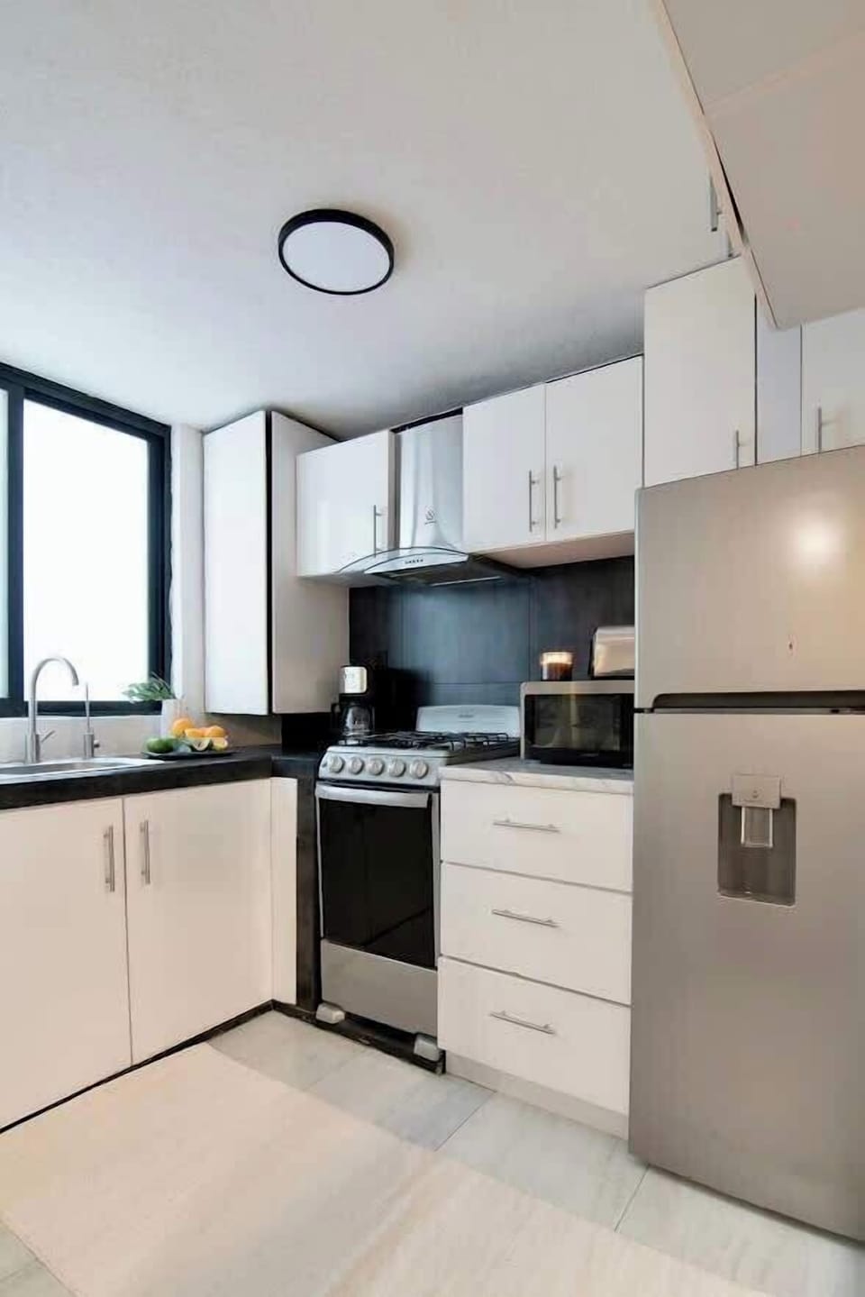 Bright kitchen space with ample storage and natural light, offering everything you need to cook and feel at home.