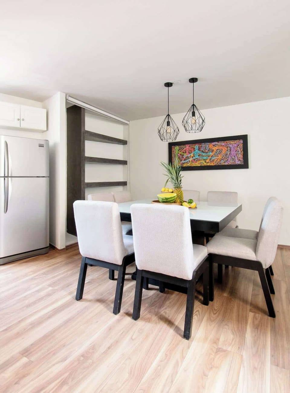 Spacious dining room with seating for six, modern décor and plenty of room to enjoy shared meals.