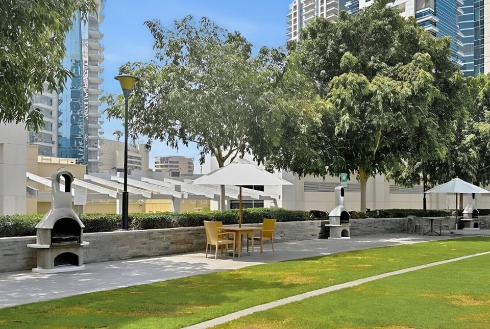 Scenic marina walkway with palm trees and city views perfect for a stroll.