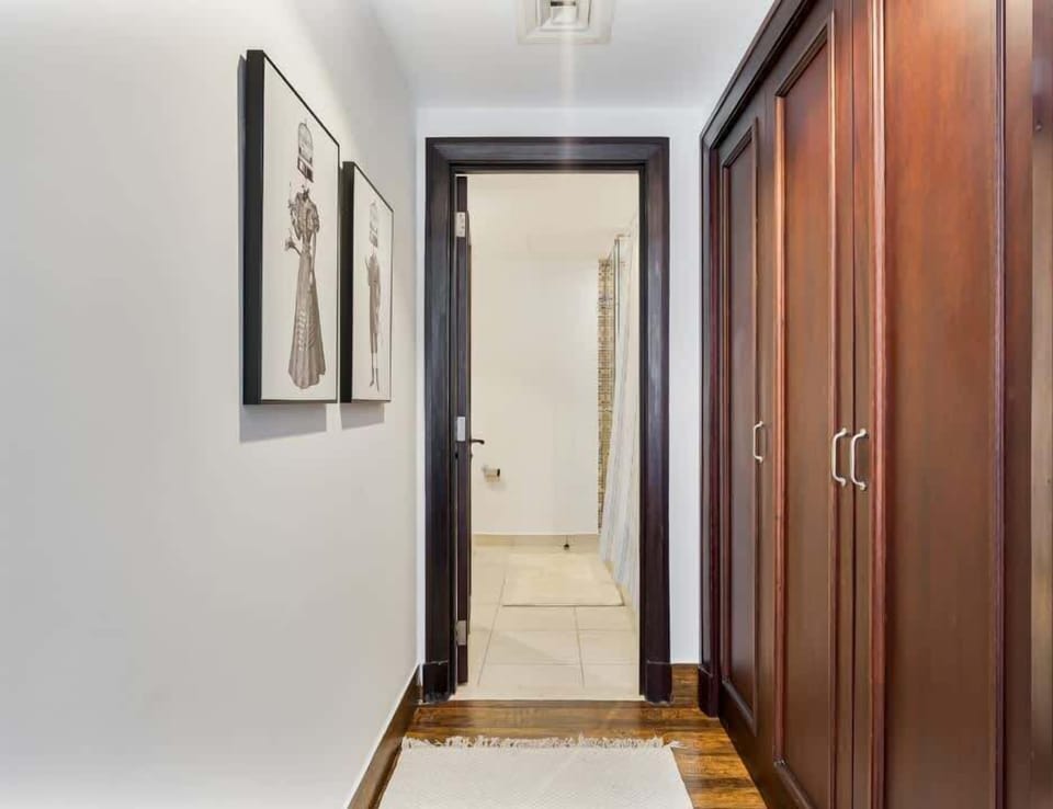 Spacious bedroom featuring a walk-in wardrobe and direct access to the washroom for added convenience and privacy.