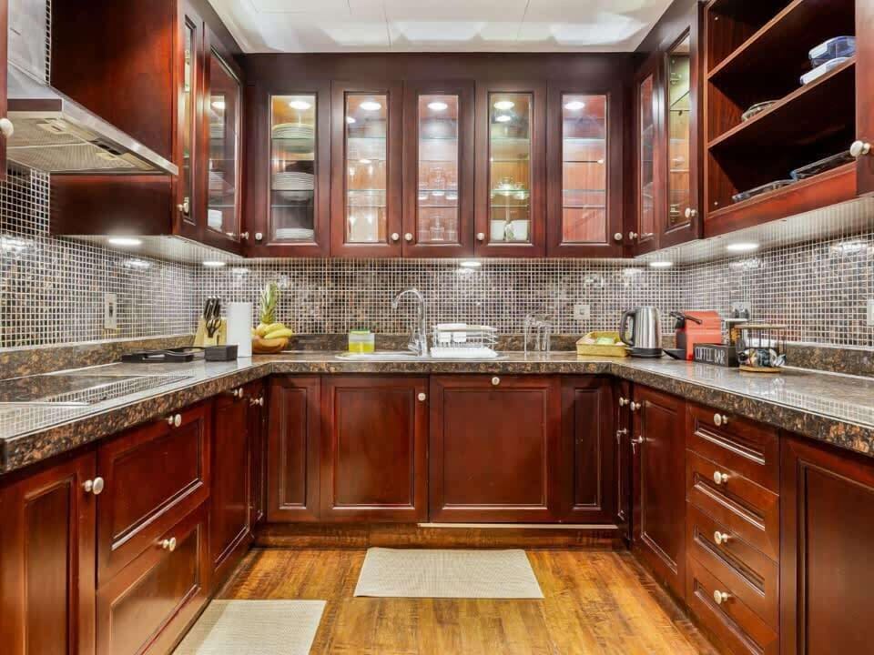 Fully equipped kitchen with all essentials, including cookware, crockery, and cutlery, as well as modern appliances such as a built-in stove and oven, microwave, kettle, coffee machine, refrigerator, dishwasher, and toaster.