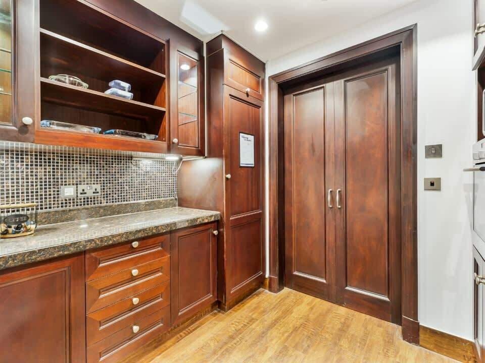 The kitchen is fully equipped and features a door, allowing it to be closed off for privacy or to keep cooking separate from the living area.
