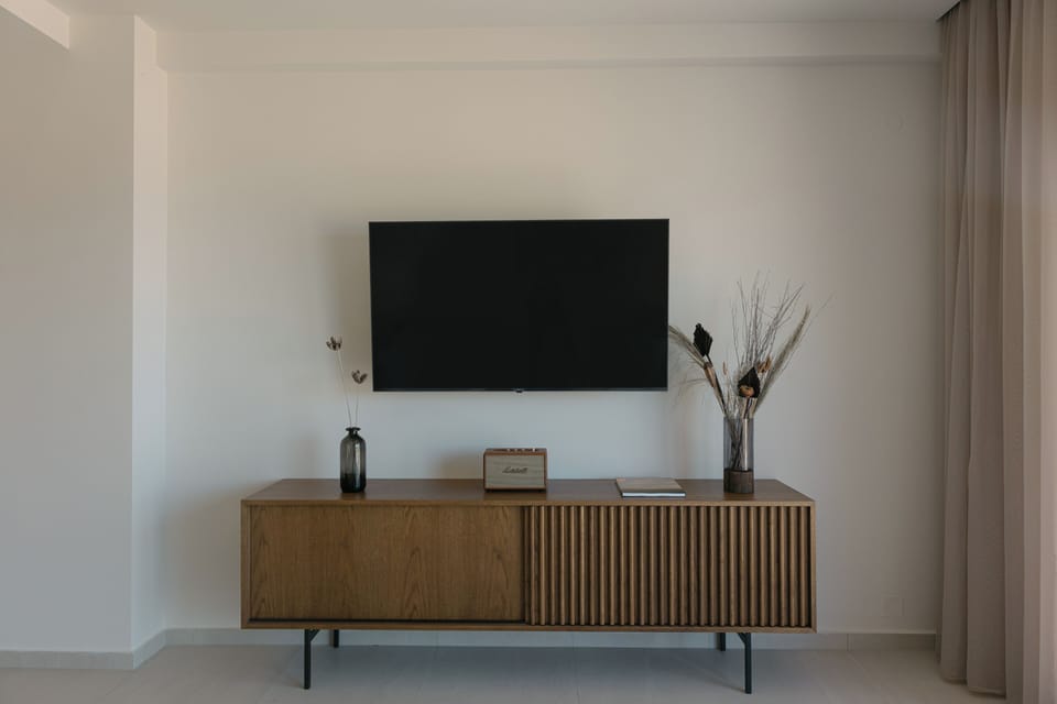 Featuring a a 55' Smart TV and a Marshall Speaker.
