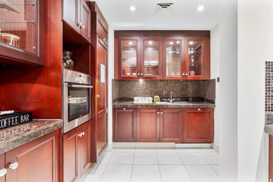 Equipped with modern appliances, including a built-in stove, oven, Dishwasher, Refrigerator, and a microwave.