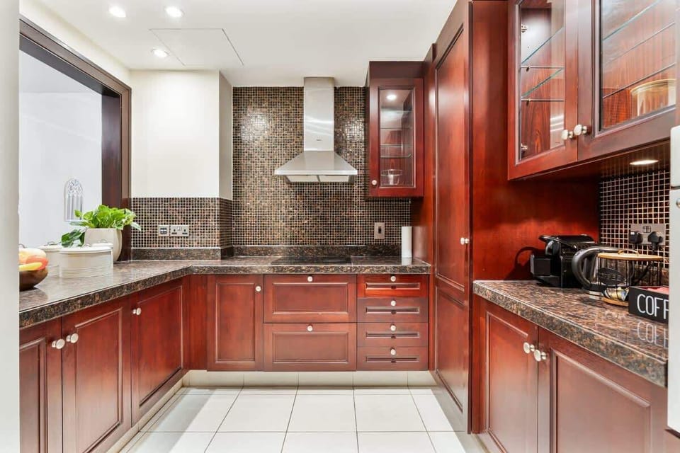Fully equipped kitchen with all essentials, including cookware, crockery, and cutlery, as well as modern appliances such as a built-in stove and oven, microwave, kettle, coffee machine, refrigerator, dishwasher.