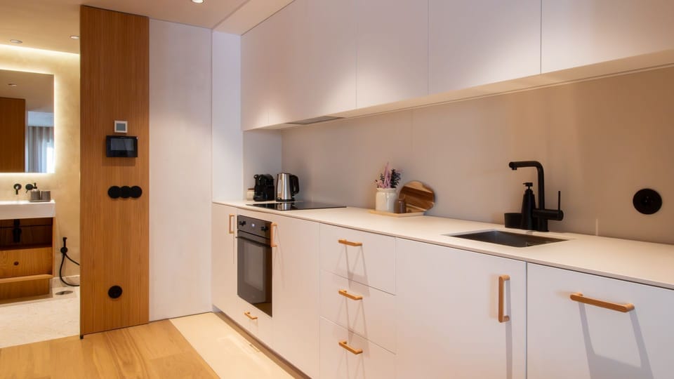 Fully equipped minimalist kitchen with integrated appliances, perfect for cooking at home in style. #CookInPorto #DesignKitchen #StayInStyle