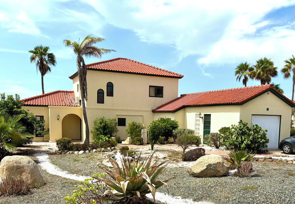 Expansive front yard with entrance to house, guest suite and garage.