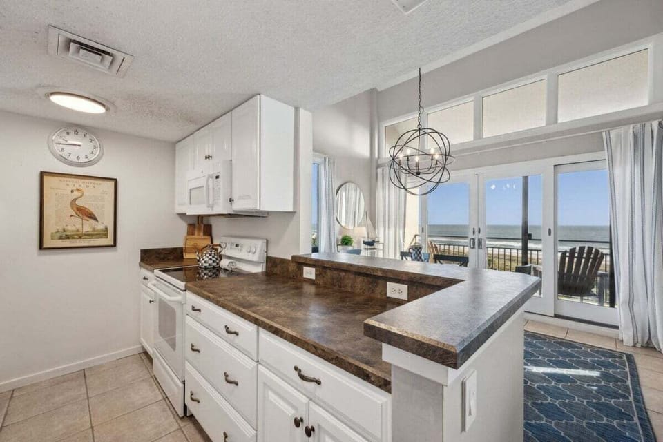 A classic coastal kitchen offering comfort and convenience, perfect for preparing beachside breakfasts or evening dinners in.