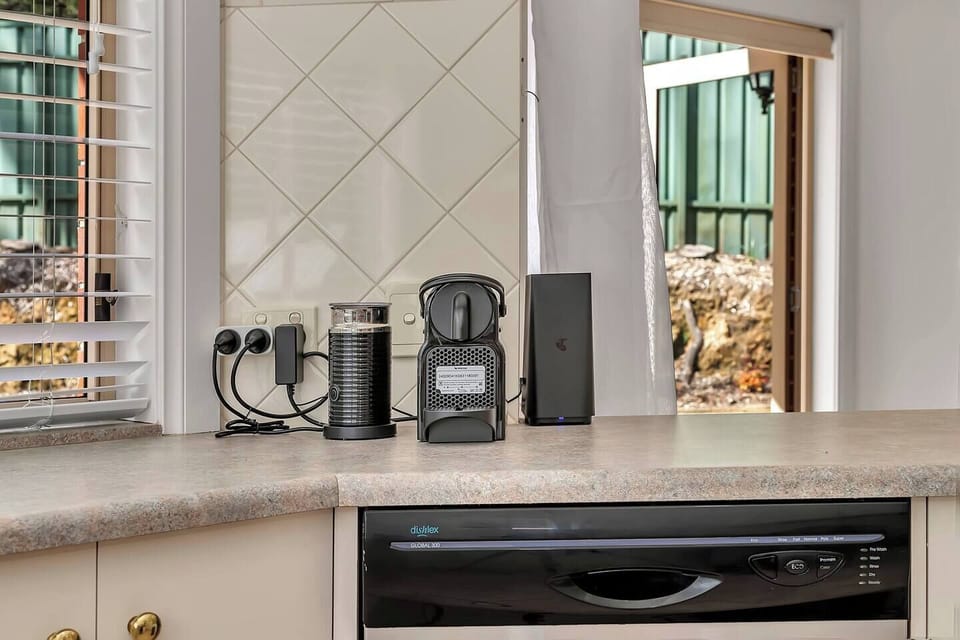 A dedicated coffee nook with an espresso machine and milk frother makes your morning ritual easy.