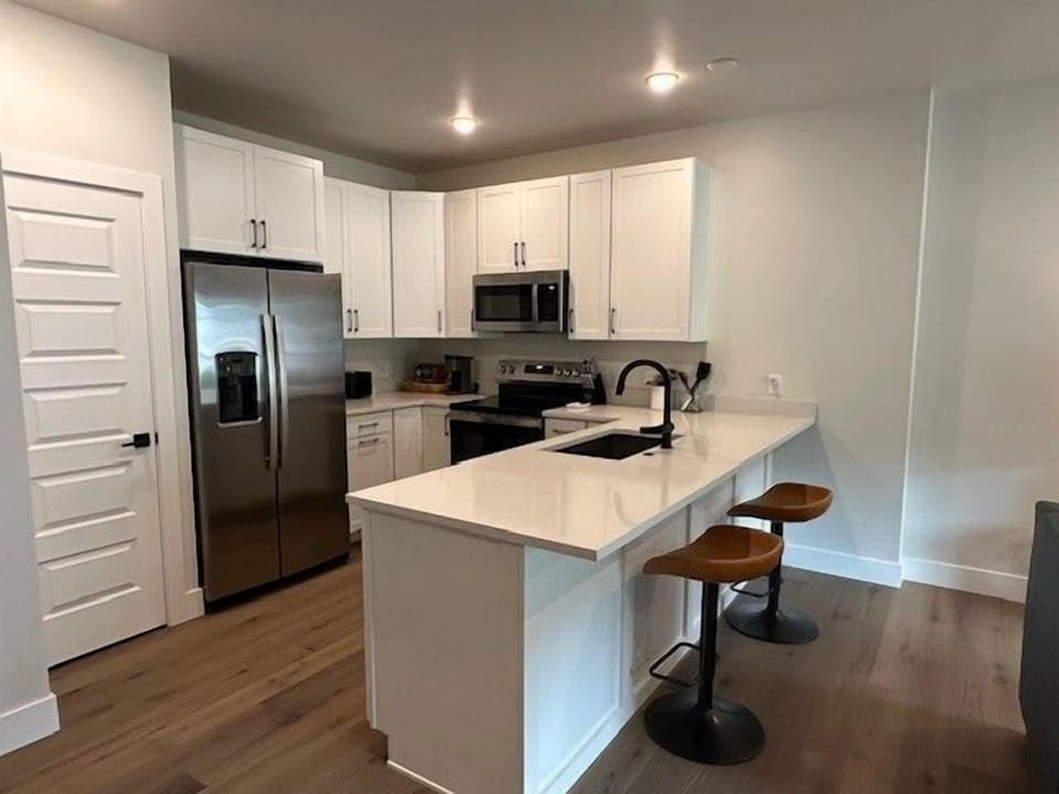 Cook with ease in the fully equipped kitchen with stainless steel appliances and bar seating.