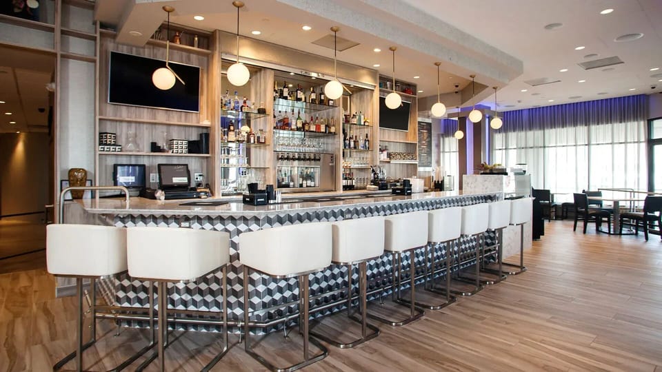 Grab a cocktail and unwind at Sixty—our chic on-site bar with stylish décor!