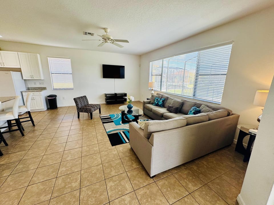 Spacious living room with abundant natural light and cozy seating