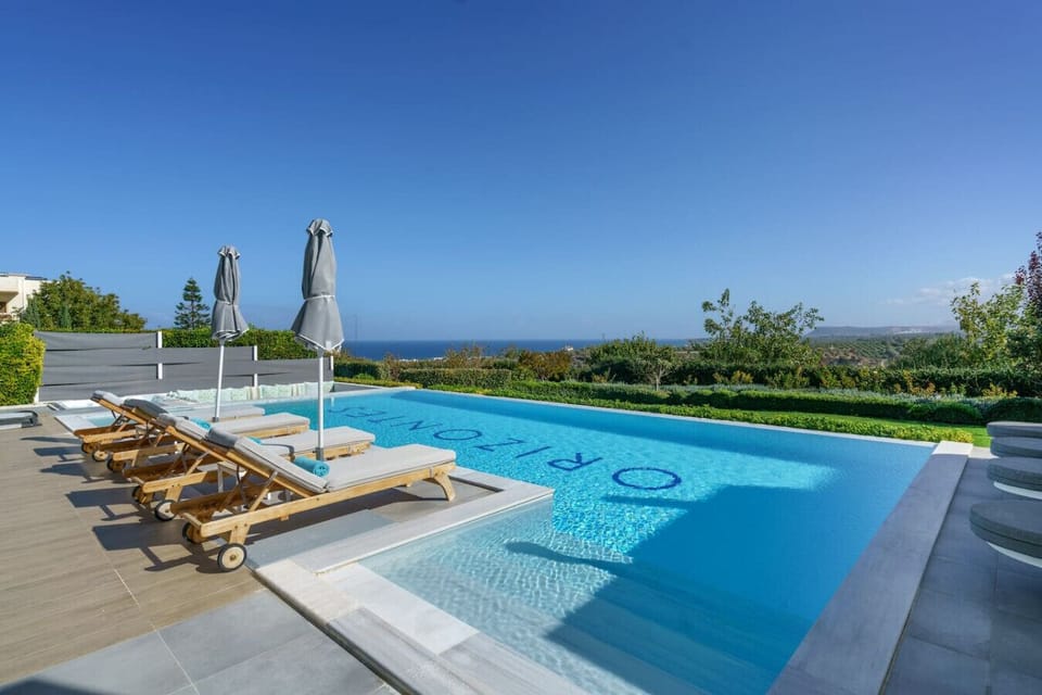 Tranquil pool retreat surrounded by greenery and sea views.