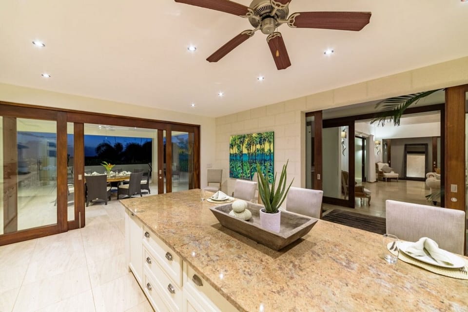 Sliding doors open to covered dining patio and living area