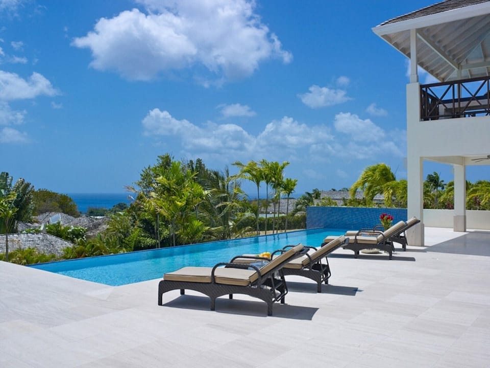Infinity pool with ocean view and sun loungers
