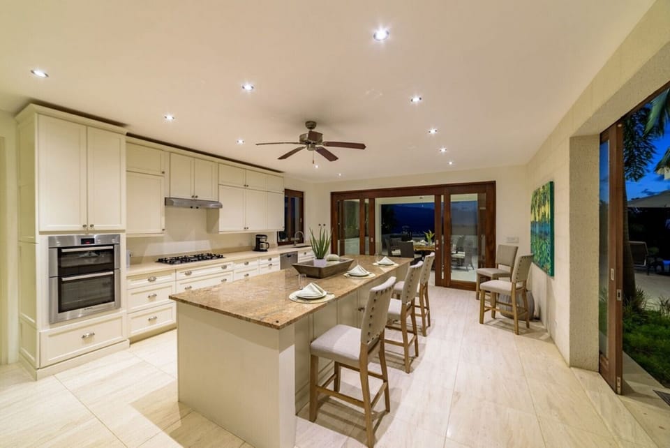 Modern kitchen with granite island and terrace access