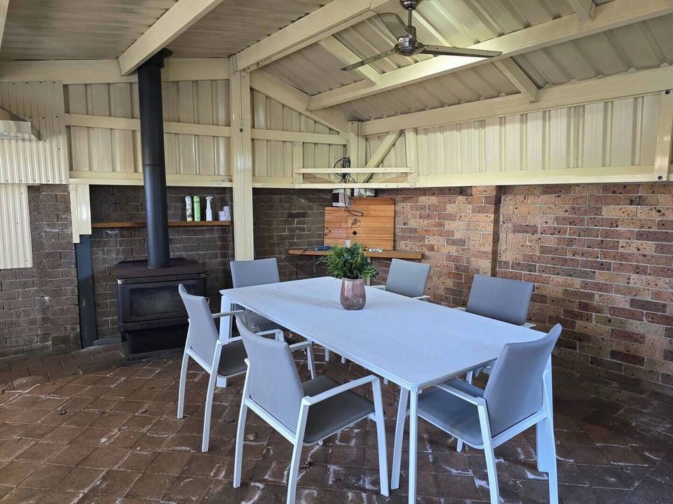 This fully enclosed outdoor dining area includes an indoor fireplace — shared and inviting year-round.