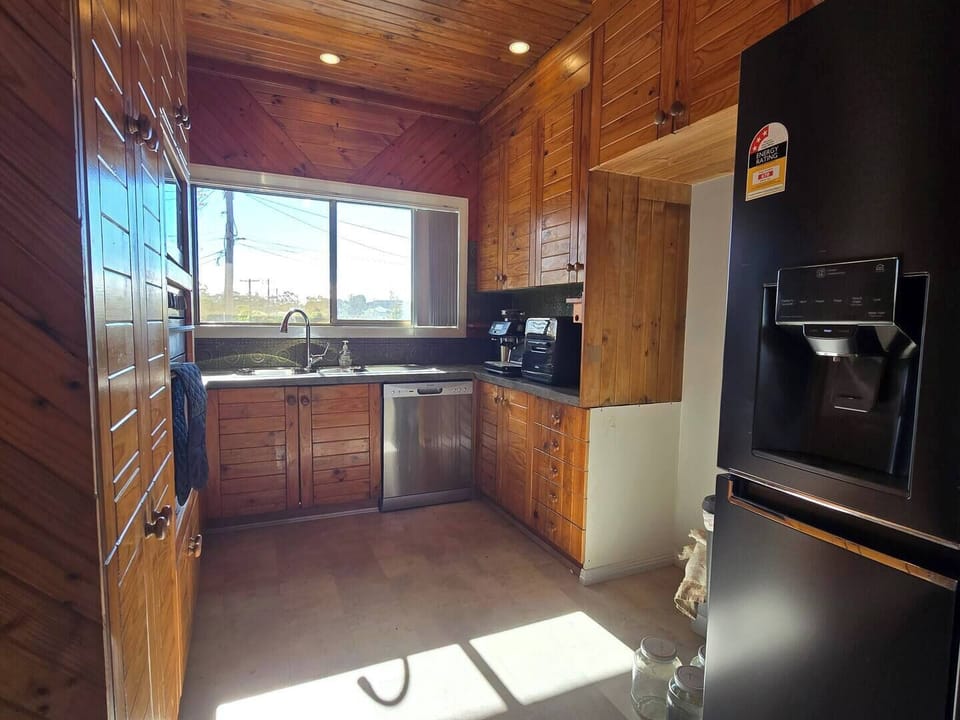 Fully equipped shared kitchen with dishwasher, air fryer, and barista-style coffee machine.