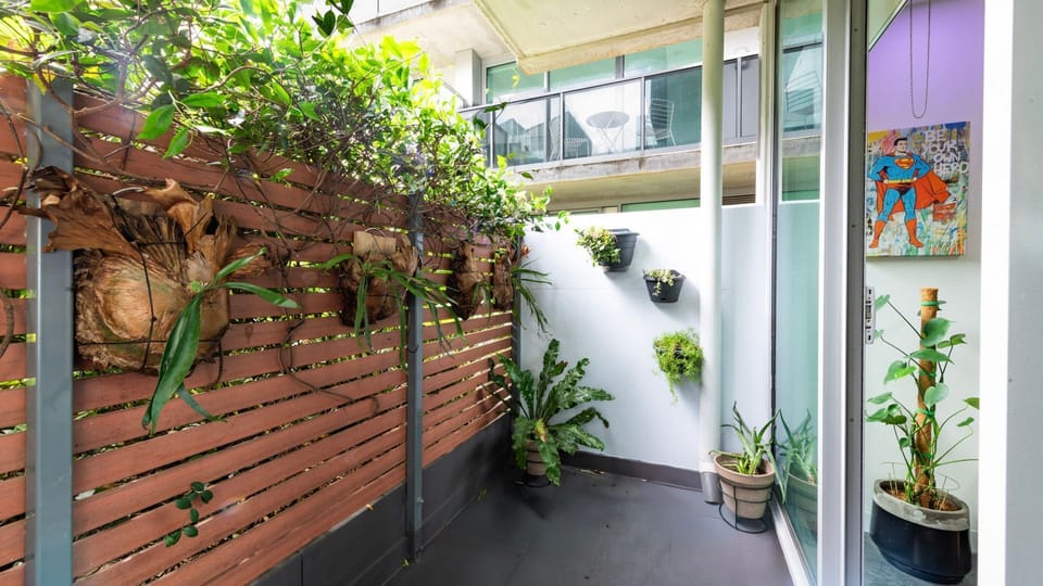 Charming courtyard lined with lush greenery — perfect for morning coffee or an evening unwind.