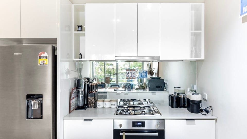 Modern kitchen with stainless steel appliances and everything you need to cook at home.