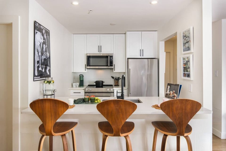 Fresh, airy kitchen with new high-end appliances and a bright bar-top dining nook.