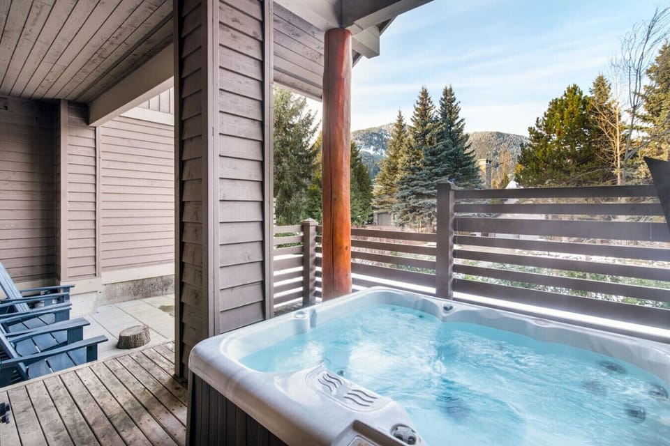 Private patio with outdoor seating, hot tub, and mountain views.