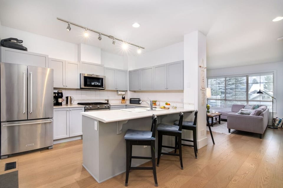 Spacious kitchen with modern appliances and ample counters.