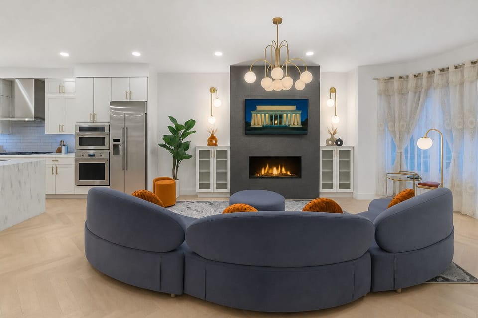 Elegant living room with a curved velvet sofa, fireplace, designer lighting.
