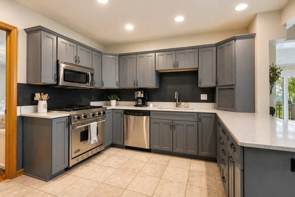 Bright, updated kitchen with quartz countertops, stainless steel appliances, and a spacious peninsula for gathering.